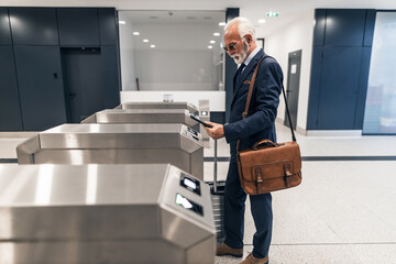 Senior Businessman Using Ticket Gate at Modern Transport Hub