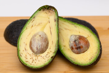 Rotten avocado unfit for consumption, cut in half, not fresh