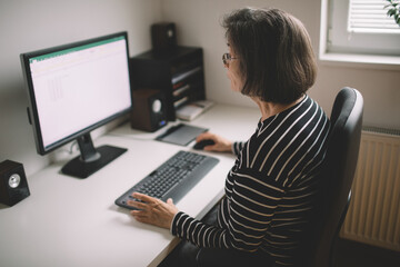 Elderly woman working from home office