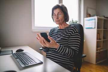 Elderly business woman using smartphone