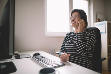 Elderly business woman on call