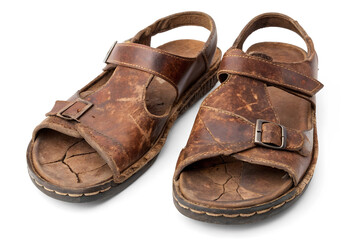 A pair of old brown leather gladiator sandals on a white or transparent background.