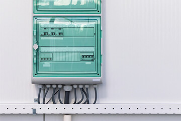 New industrial electricity distribution panel board on a white wall
