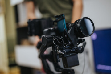 A close-up of modern professional videography equipment, including a high-resolution camera setup with accessories, used in a studio setting, emphasizing technology's role in media production.
