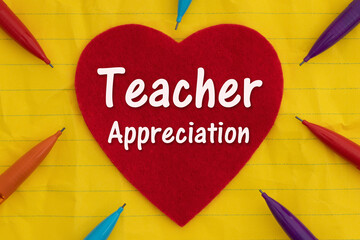 Teacher Appreciation with colored pencils and hearts on yellow ruled loose leaf notebook paper