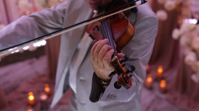 Symphony orchestra on stage, hands playing violin. Vintage style.