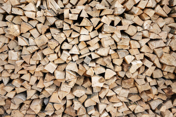 Stack of neatly arranged firewood logs prepared for burning or storage