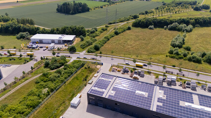 A large building with solar panels on the roof. Aerial view.