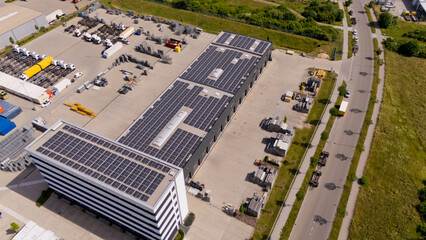 A large building with solar panels on the roof. Aerial view.