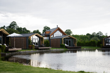 Scenic lakeside cabins surrounded by tranquil greenery and serene water reflections