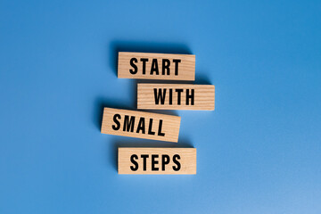 start with small steps words text on wooden blocks isolated on blue background