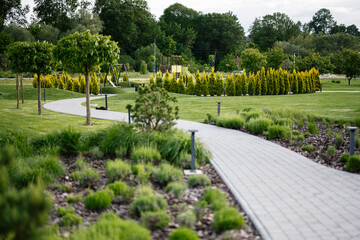 Beautiful landscaped park with greenery, trees, and pathways on a sunny day