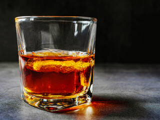 Strong alcohol drink. Whisky in glass with ice, Whisky, bourbon or cognac. Hard strong alcoholic drink