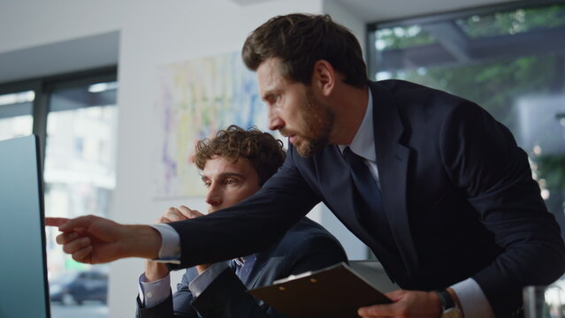 Man mentor helping colleague solving problem at office coworking space closeup - Powered by Adobe