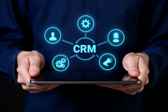 Businessman Holding Tablet Showing CRM System Diagram with Customer Relationship Management Icons
