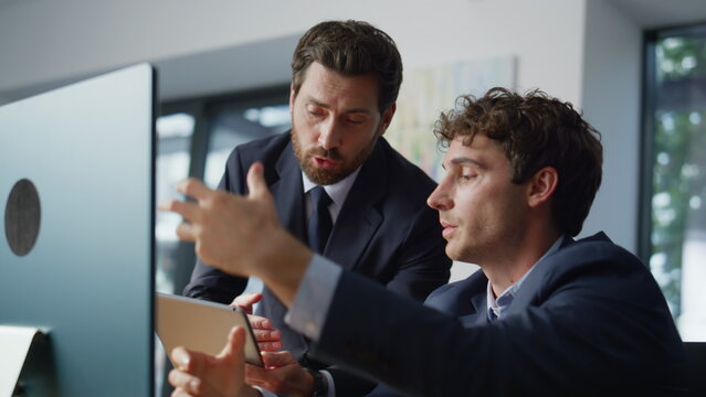 Two coworkers brainstorming together office closeup. Mentor helping colleague