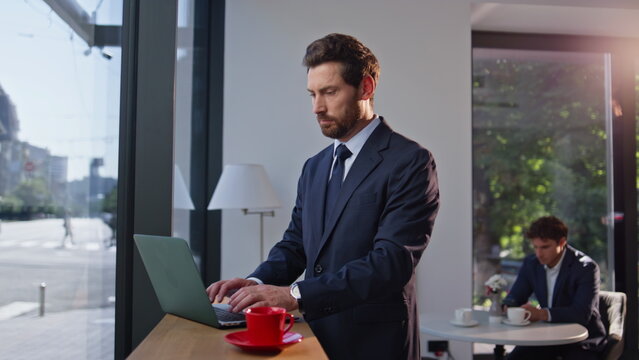 Director browsing laptop cafe thinking project zoom on. Ceo sipping beverage - Powered by Adobe