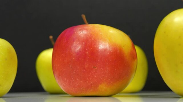 Ripe apples rotates on black background, close-up shot video