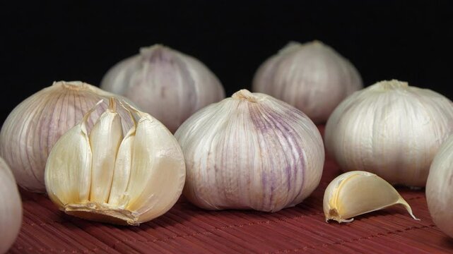 Garlic, Allium sativum, species of bulbous flowering plants in genus Allium. Garlic - very healthy product with many beneficial properties for health, zoom-out video