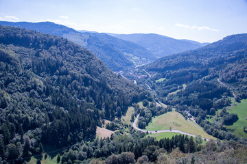 Fototapeta premium Panoramic summer view over the lush green hills and dense woodland of Germany’s Black Forest, seen from Sommerberg near Bad Wildbad.