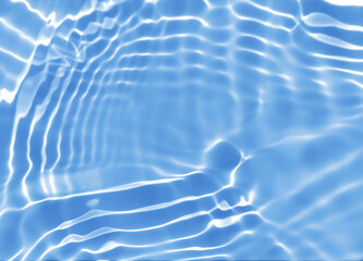 Abstract blurred shades of blue water background. Light and shadow ripples or splashes surface of water texture. Water waves with shining and reflection pattern photography for​ design artwork.