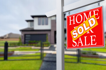 Sold Home For Sale Real Estate Sign in Front of Beautiful New House.