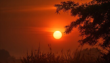 Fading sun caught in prehistoric smoke veil with glowing amber horizon
