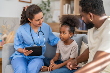 Obraz premium Doctor use tablet for medical checkup consulting african child about health while father sits beside, concept of pediatric healthcare, digital diagnosis, telemedicine, patient care and family support