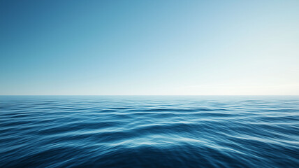 Fototapeta premium Calm ocean water with soft ripples beneath a bright, clear blue sky. The vast horizon extends smoothly