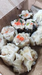 Chinese steamed dumpling with shrimp in take away food box, selective focus