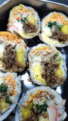 Sushi roll with pork, egg and vegetables on black background. Sushi roll with tuna, egg and vegetables. Japanese food. 