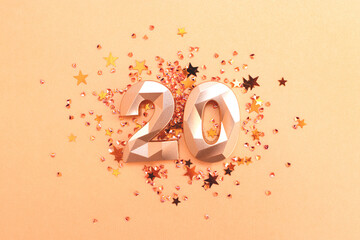 Golden number twenty and stars confetti. Monochrome concept.