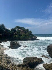 large coral rocks on the seashore hit by waves