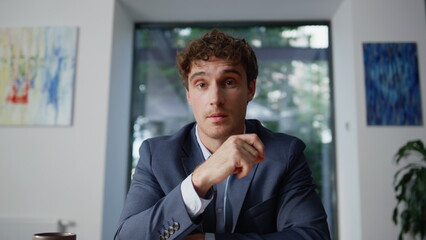 Online tutor talking video call office closeup pov view. Smiling man consulting