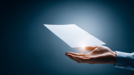 A hand holding a floating sheet of paper against a dark background, symbolizing innovation.