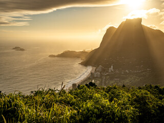 Golden Sunset Over Rio De Janeiro From Two Brothers Mountain: Dramatic Sunbeams Streaming Through Coastal Peaks Above The Atlantic Ocean And Leblon Beach