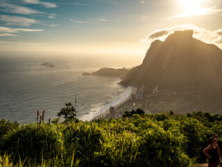 Golden Sunset Over Rio De Janeiro From Two Brothers Mountain: Dramatic Sunbeams Streaming Through Coastal Peaks Above The Atlantic Ocean And Leblon Beach