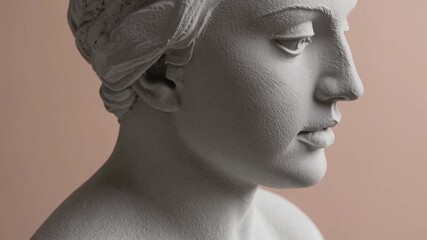 Close-up of a plaster bust of Sappho. Side view, place for text. Peach fuzz is color of year 2025.
