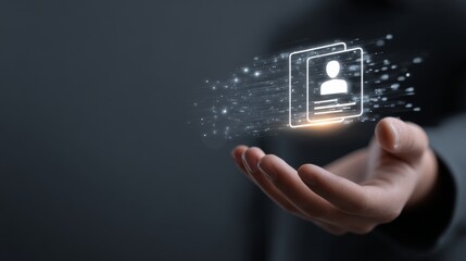 Hand holding digital identity card with glowing effect in dark background.