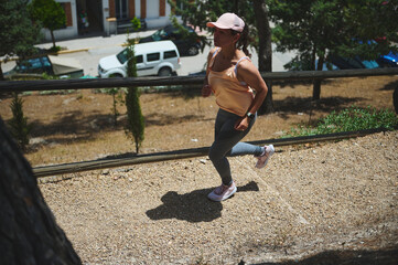 Fit Woman Running Outdoors on a Sunny Day in a Park Setting