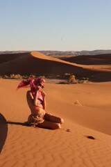 Beautiful woman in the dunes of the desert