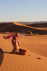 Beautiful woman in the dunes of the desert