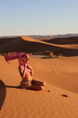 Beautiful woman in the dunes of the desert