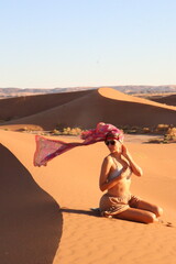 Beautiful woman in the dunes of the desert