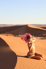 Beautiful woman in the dunes of the desert