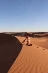 Beautiful woman in the dunes of the desert