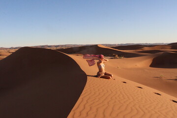Beautiful woman in the dunes of the desert