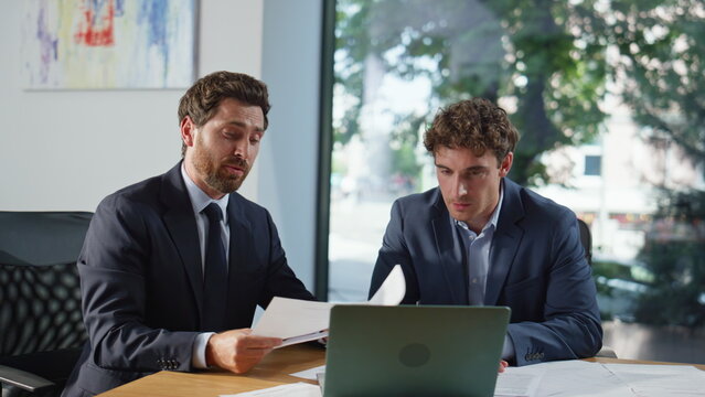Fototapeta Confident managers talking online interview looking laptop at workplace closeup