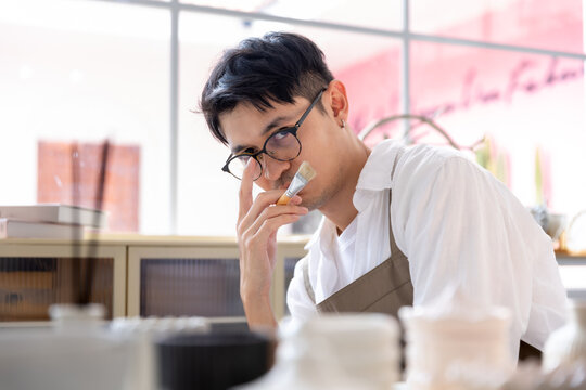 A man is looking at his product to develop a new one.