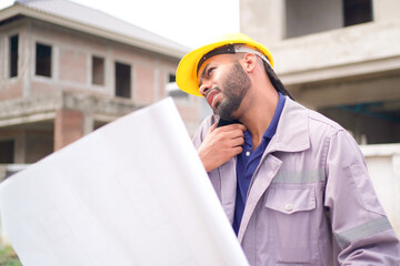 Civil engineer is working in construction site.